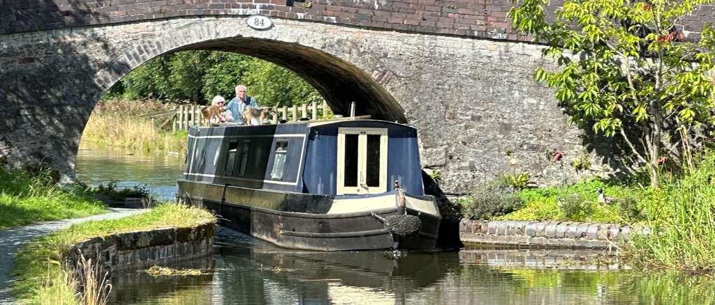 A canal boat going under a bridge on the Montgomery Canal